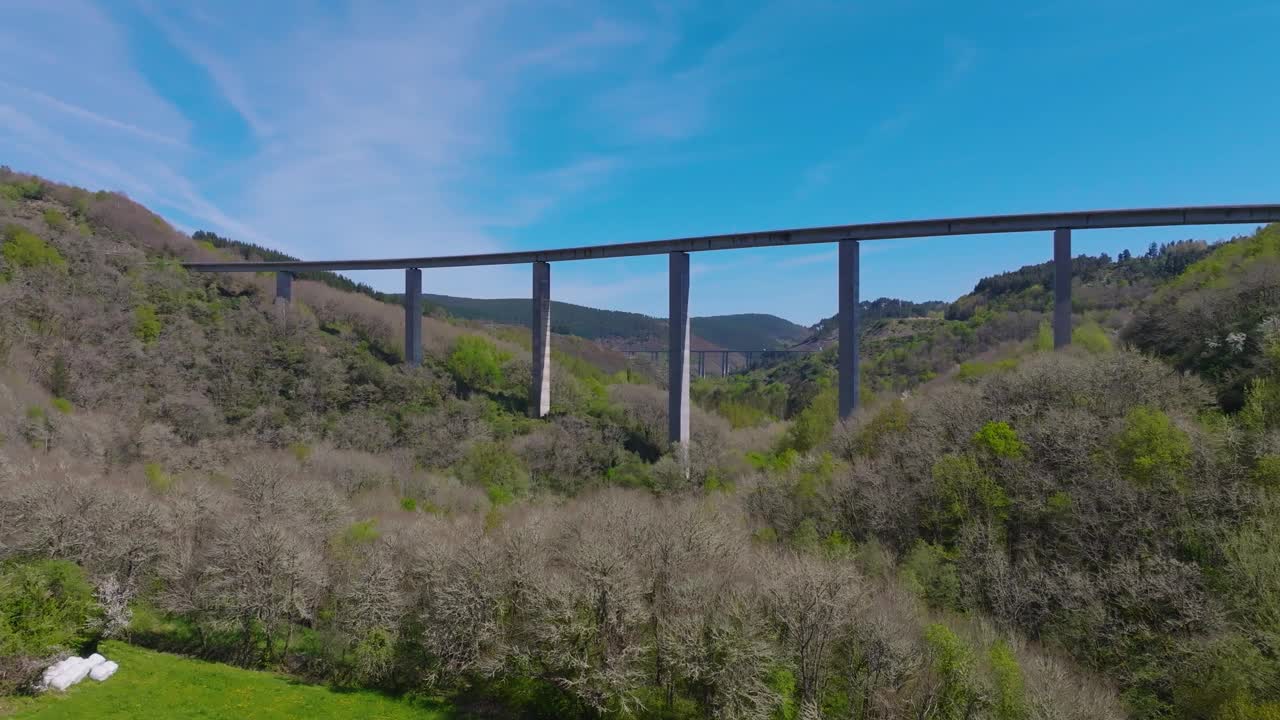 无人机拍摄的高架公路穿过西班牙卢戈贝塞雷亚市附近山区的森林视频素材