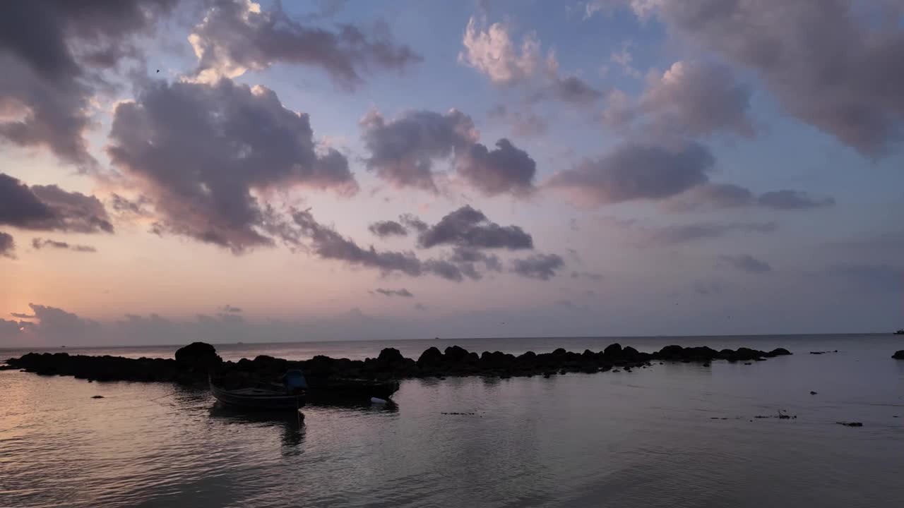 黄昏的色调笼罩在苏梅岛宁静的海面上，小船和岩石海岸，宁静的心情视频素材