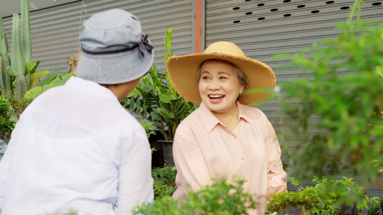 一群欢快的亚洲老年妇女一起在街市购物。视频素材