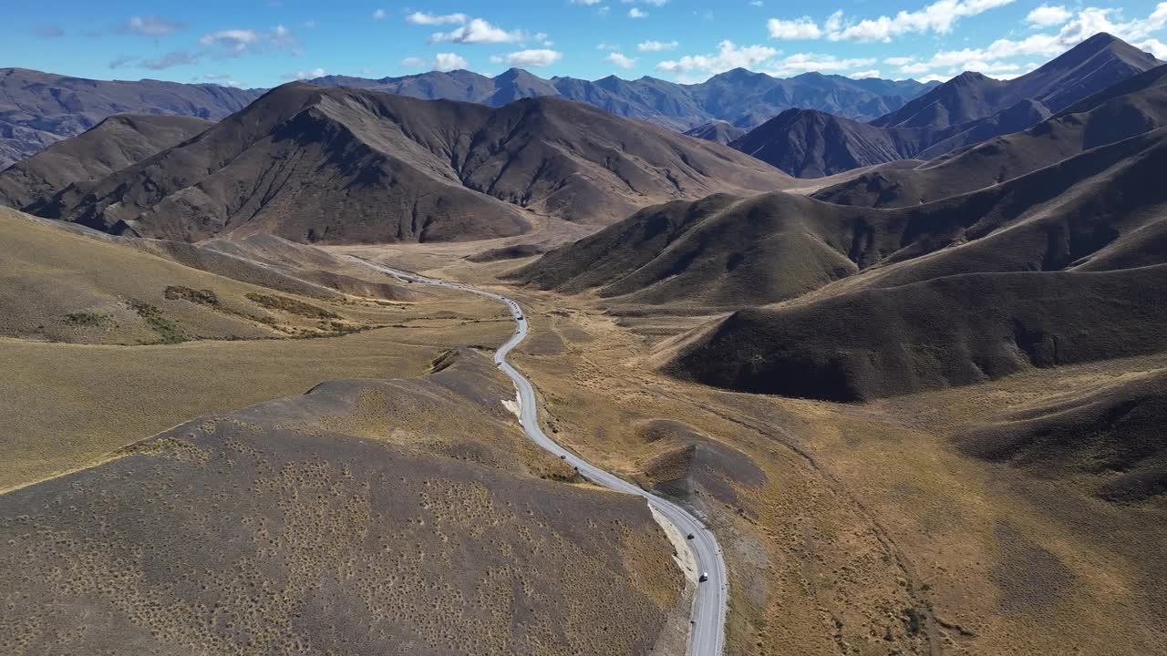 自驾游，在林迪斯山口风景公路上行驶。新西兰的山景。无人机鸟眼。视频素材