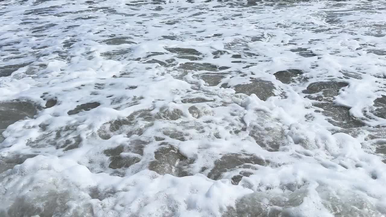 有泡沫的平静巨浪。海浪拍打着海上的鹅卵石。翻滚的海浪。夏日天堂海滩背景。强大的海浪视频素材