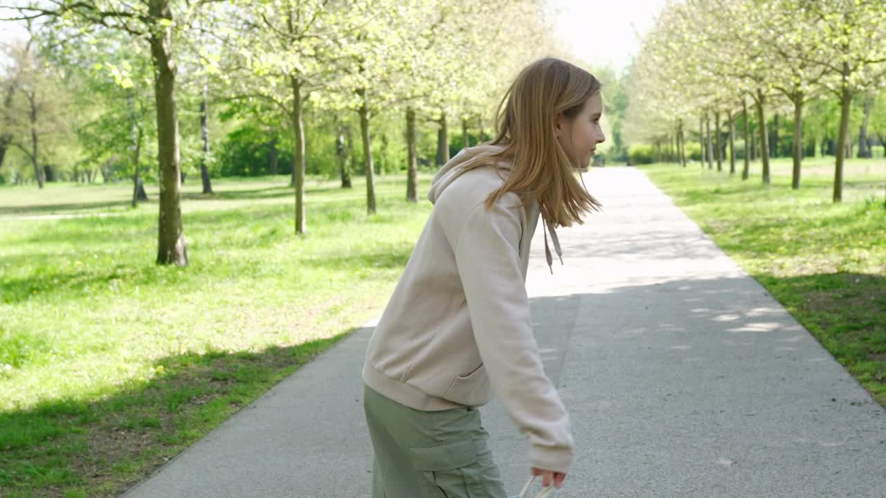 可爱的小女孩放学后在公园里玩她的背包视频素材