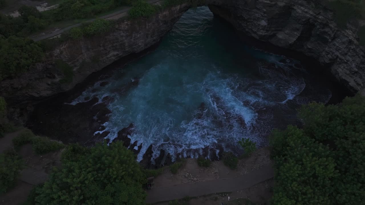 鸟瞰图的破碎海滩与拱门和海湾在日落，印度尼西亚。视频素材