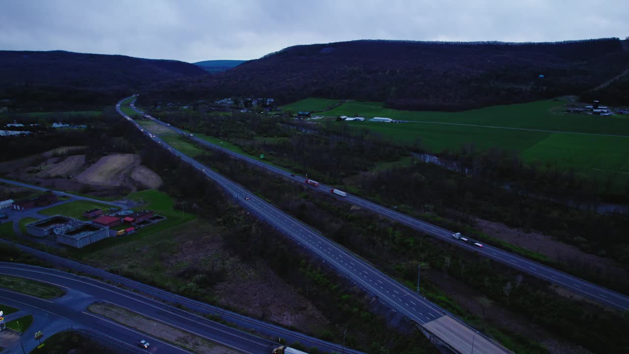 宾夕法尼亚州州际公路的夜景，迎合半卡车物流。运输和货运活动的空中透视。视频素材