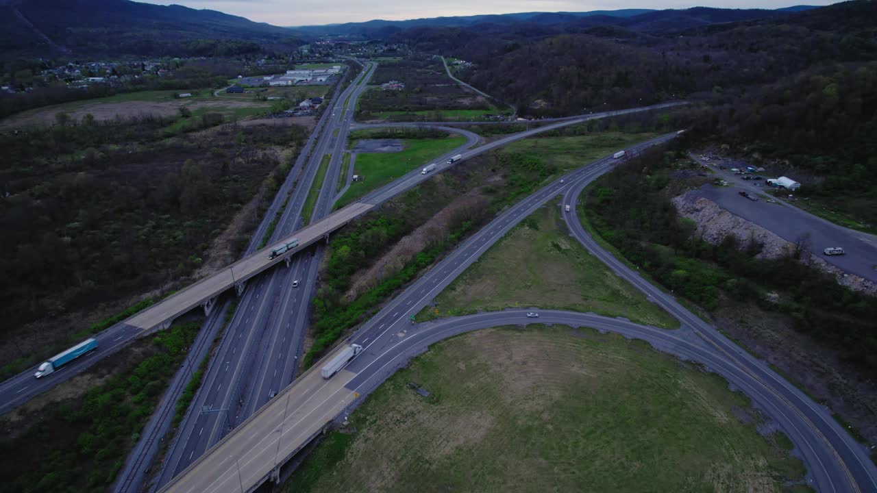 黄昏时分，航拍宾夕法尼亚州农村地区一个复杂的高速公路交汇处，有多个坡道和合并车道。视频素材