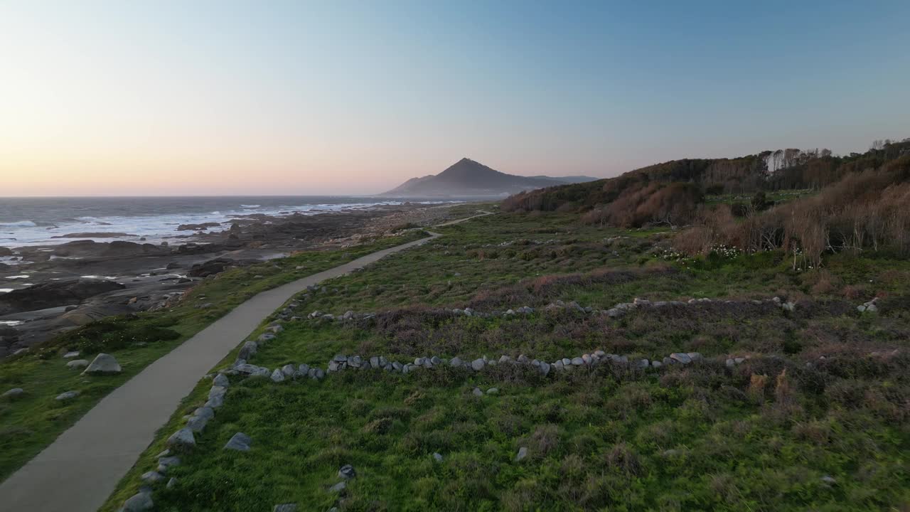 鸟瞰海岸路径和日落时的山脉，葡萄牙。视频素材