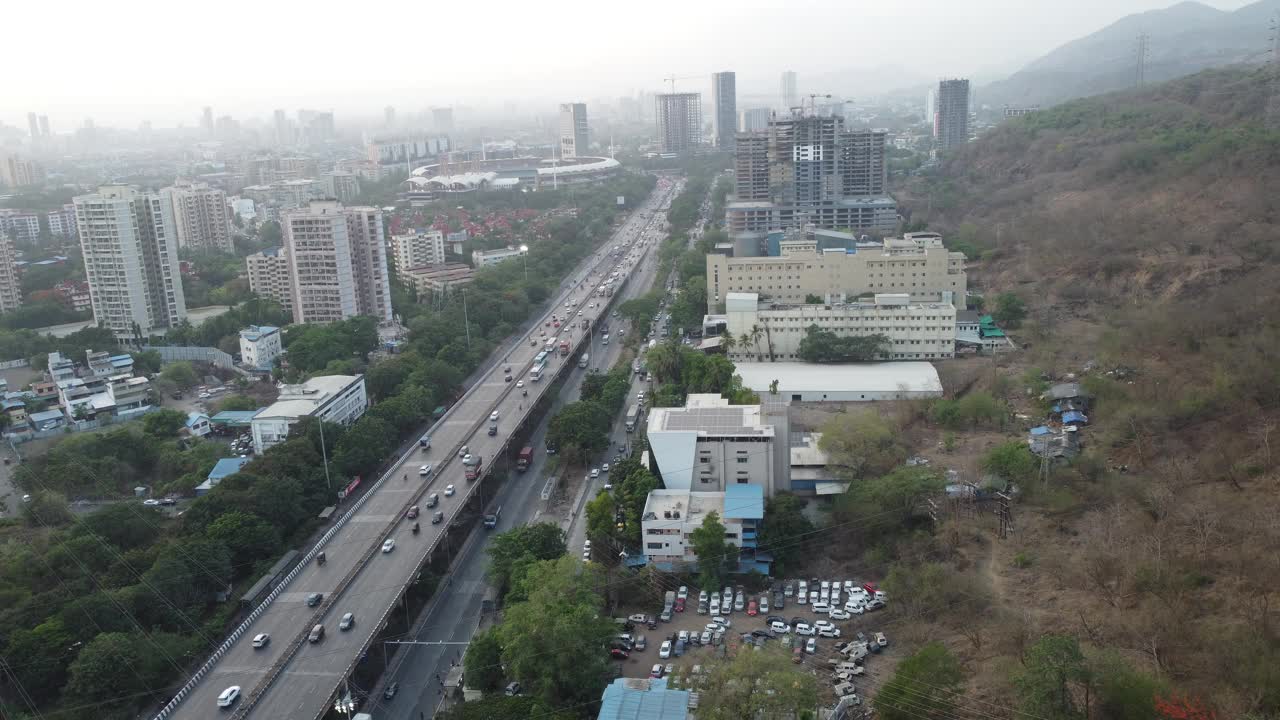 空中无人机视图的新孟买天际线在Nerul和多车道国家高速公路上的交通流量-锡安潘维尔高速公路或孟买萨塔拉高速公路从无人机的视角在一个抽象的视频片段。视频素材