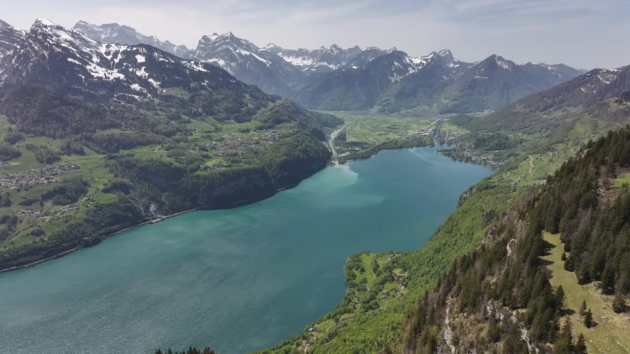 瑞士瓦伦塞湖风景如画的鸟瞰图，瓦伦塞湖宁静的湖泊坐落在被雪山环绕的山谷中。视频素材