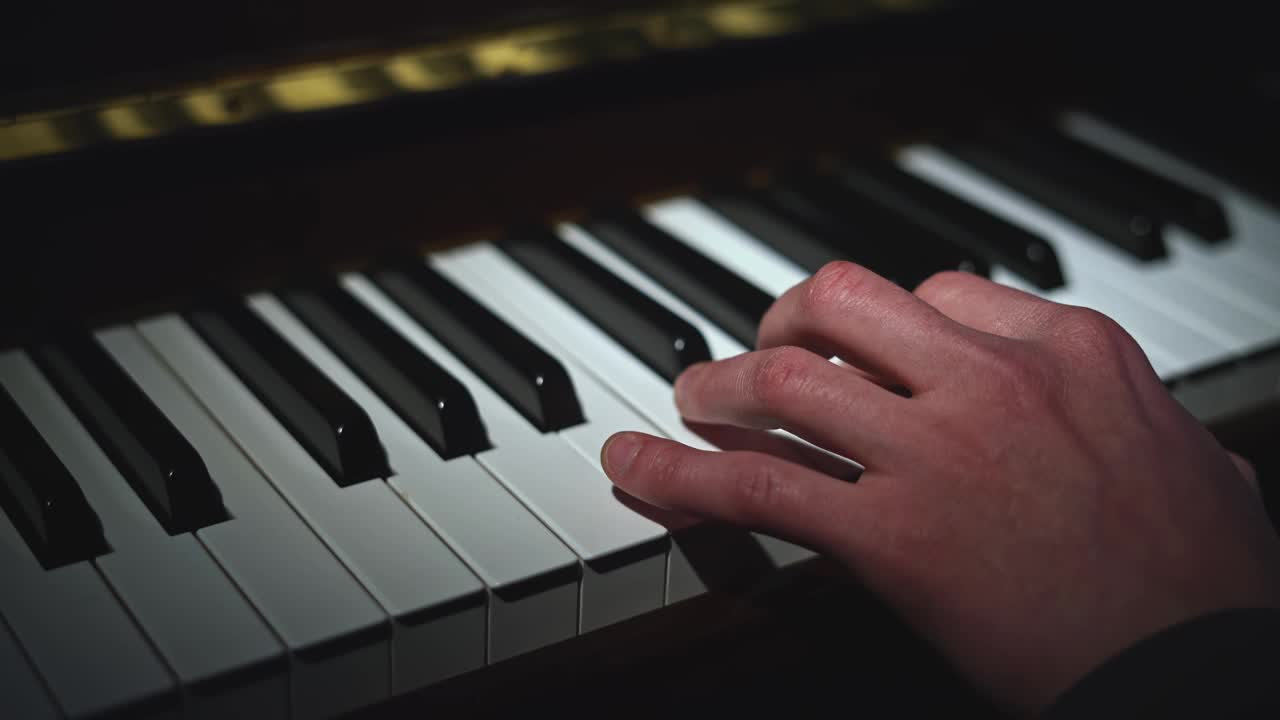 弹钢琴只用左手。媒体。演奏乐器的人的近景视频下载