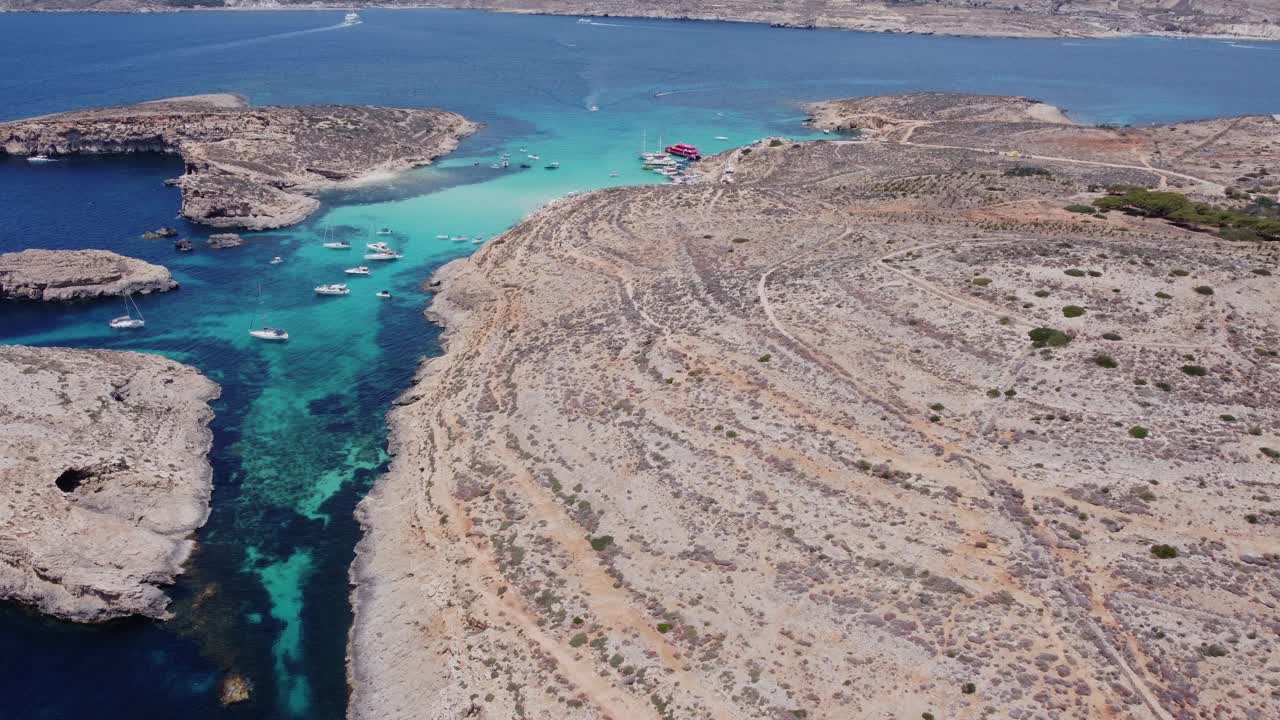 科米诺岛鸟瞰图，马耳他的一部分。蓝色的泻湖，夏天，船，蓝色的海。建立无人机拍摄视频下载