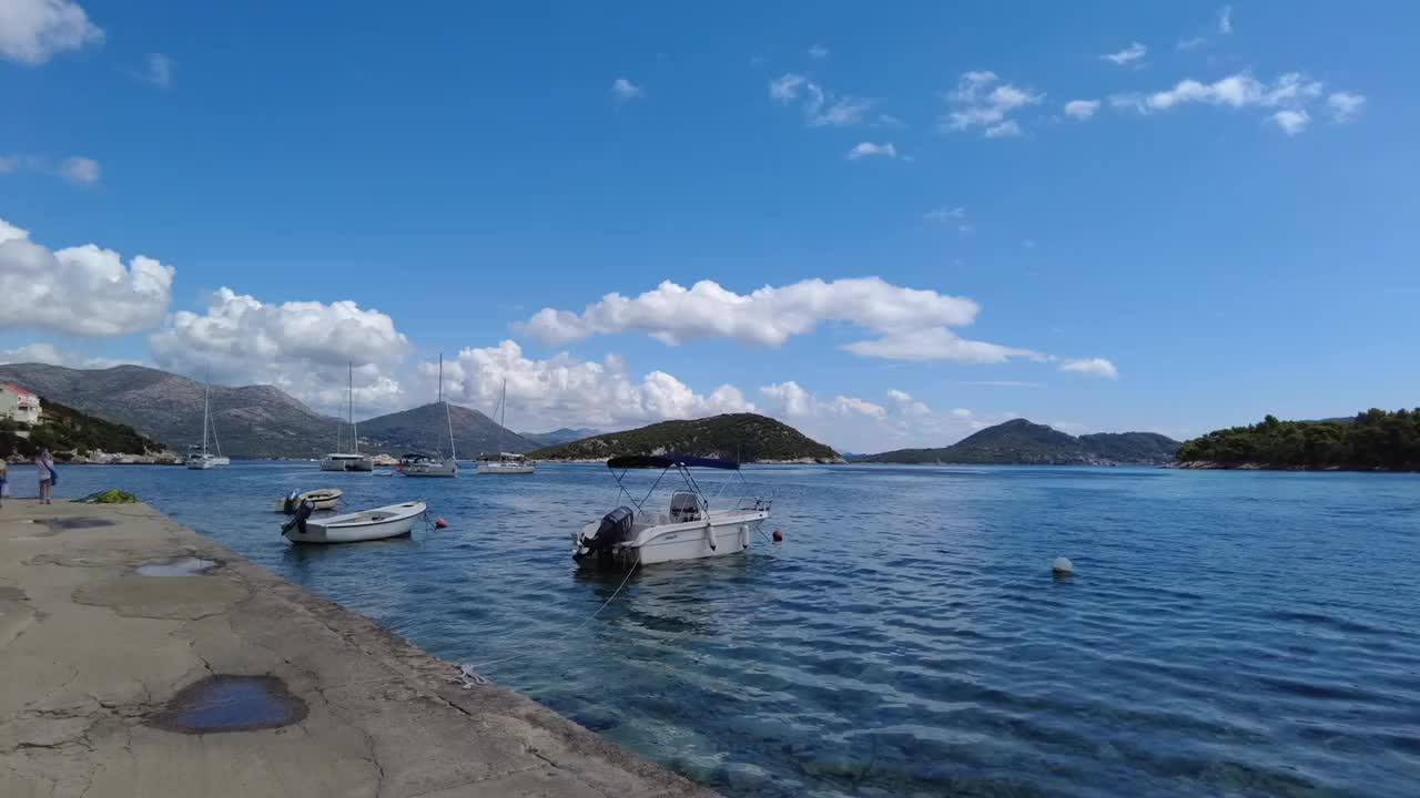 在一个阳光明媚的日子里，船只漂浮在克罗地亚埃拉菲提群岛附近的蓝色大海上视频素材