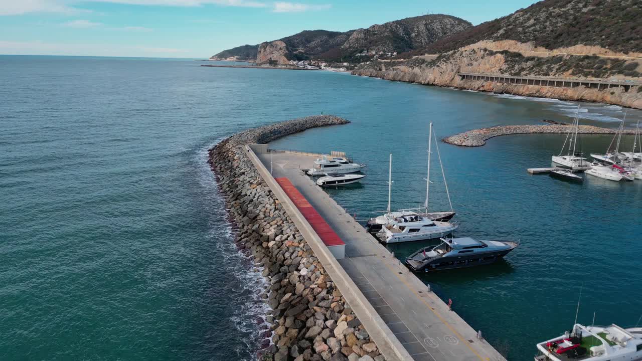 豪华游艇停靠在沿着巴塞罗那海岸线的风景优美的吉尼斯塔港，鸟瞰视频素材