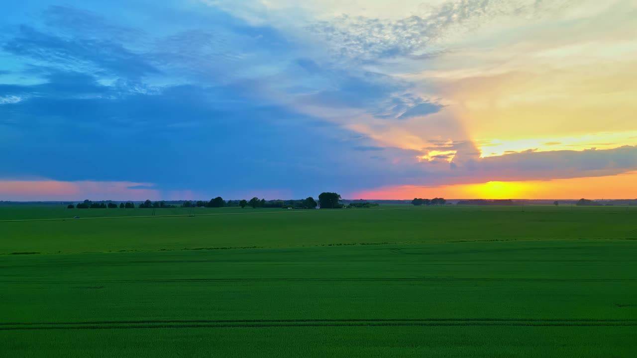 日落时翠绿的田野，美丽的天空，空中缓慢的无人机自然视频素材