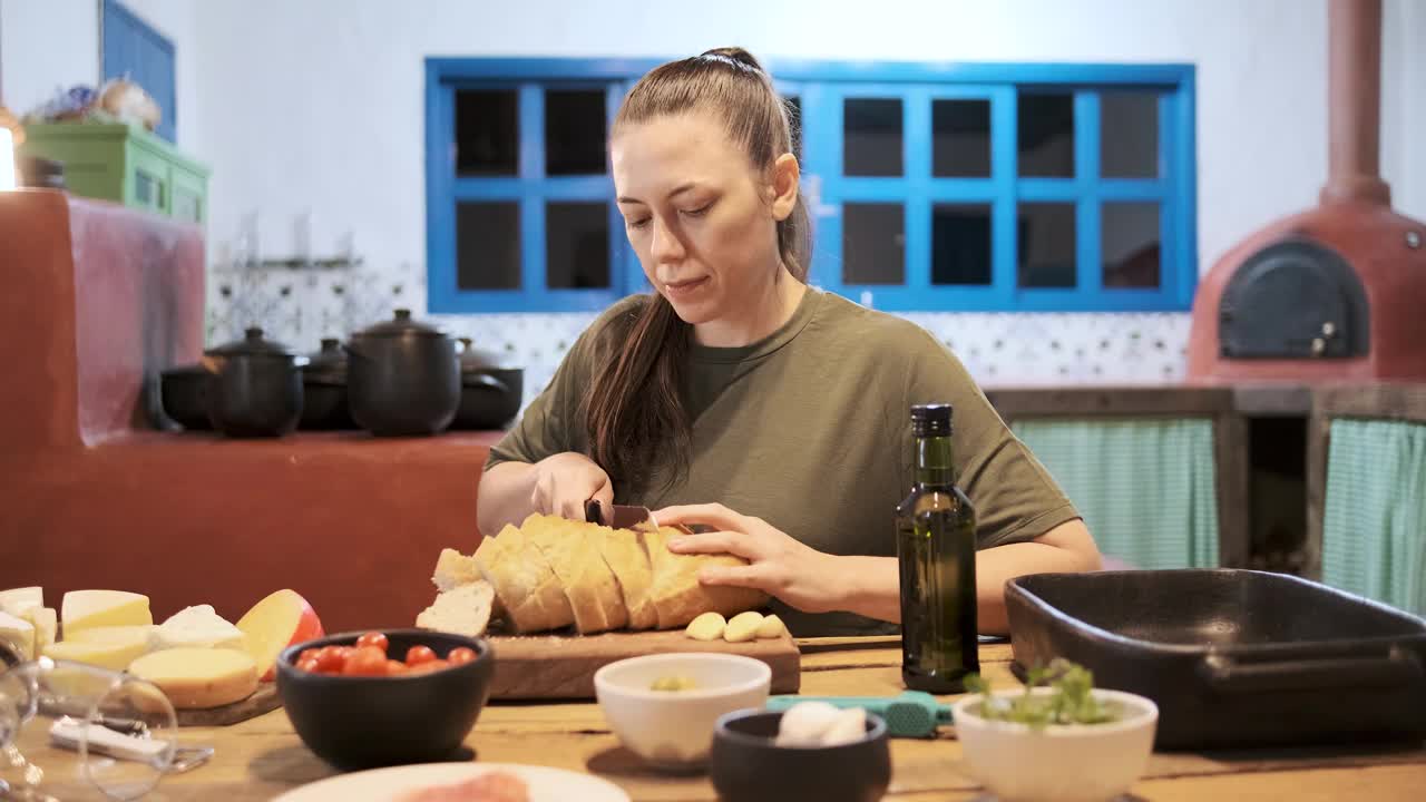 正在切面包准备烤面包的年轻女子视频下载