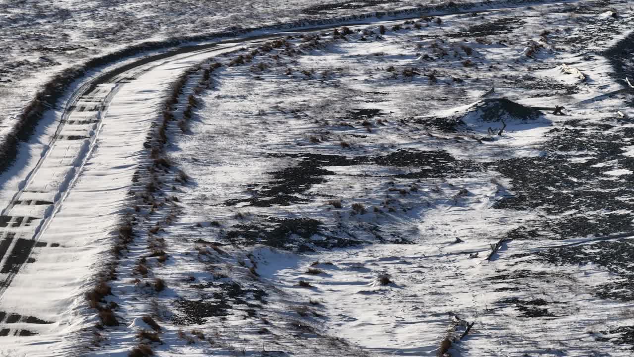 18世纪的古村落圣克莱尔湾，冬日里，无人驾驶飞机在路边结冰的雪地上飞行视频下载