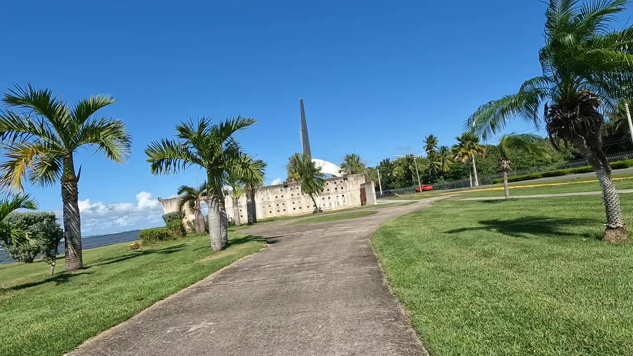 沿着波多黎各卡罗莱纳海滩附近的自行车道骑行，背景是棕榈树和热带植被(冒险旅行加勒比海度假)运动视频素材