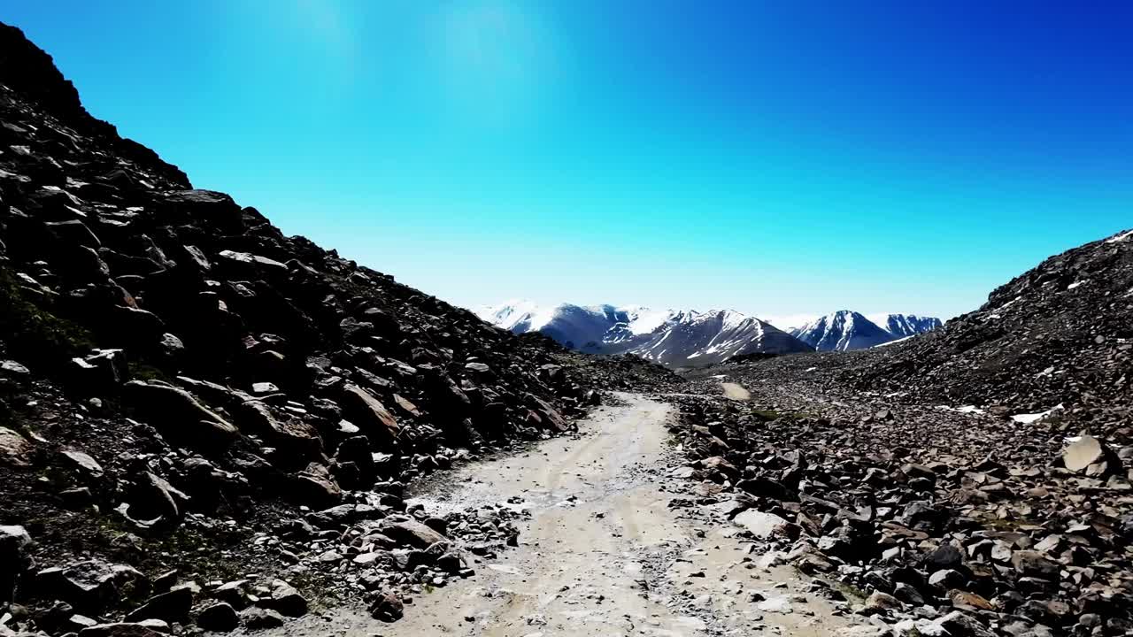 越野驾驶穿过布满岩石的雪山视频素材