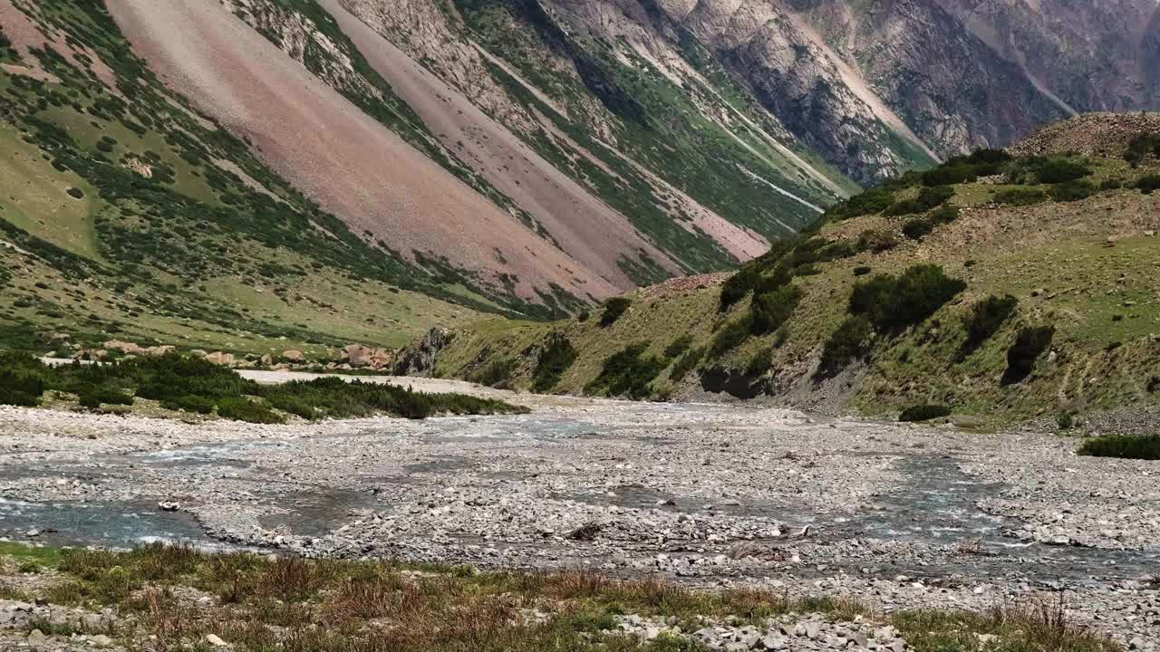 一条岩石河流穿过山沟的夏季风景视频素材