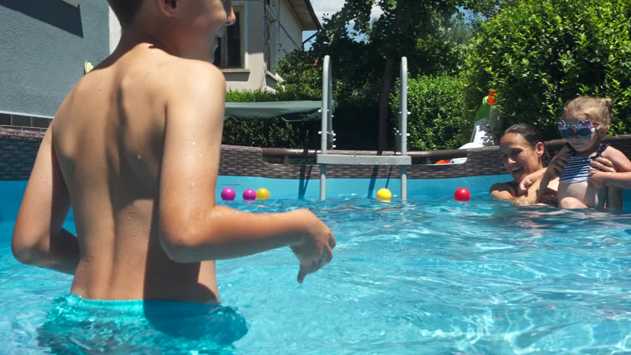 夏季居家旅游。在家泳池边的家庭日。视频素材