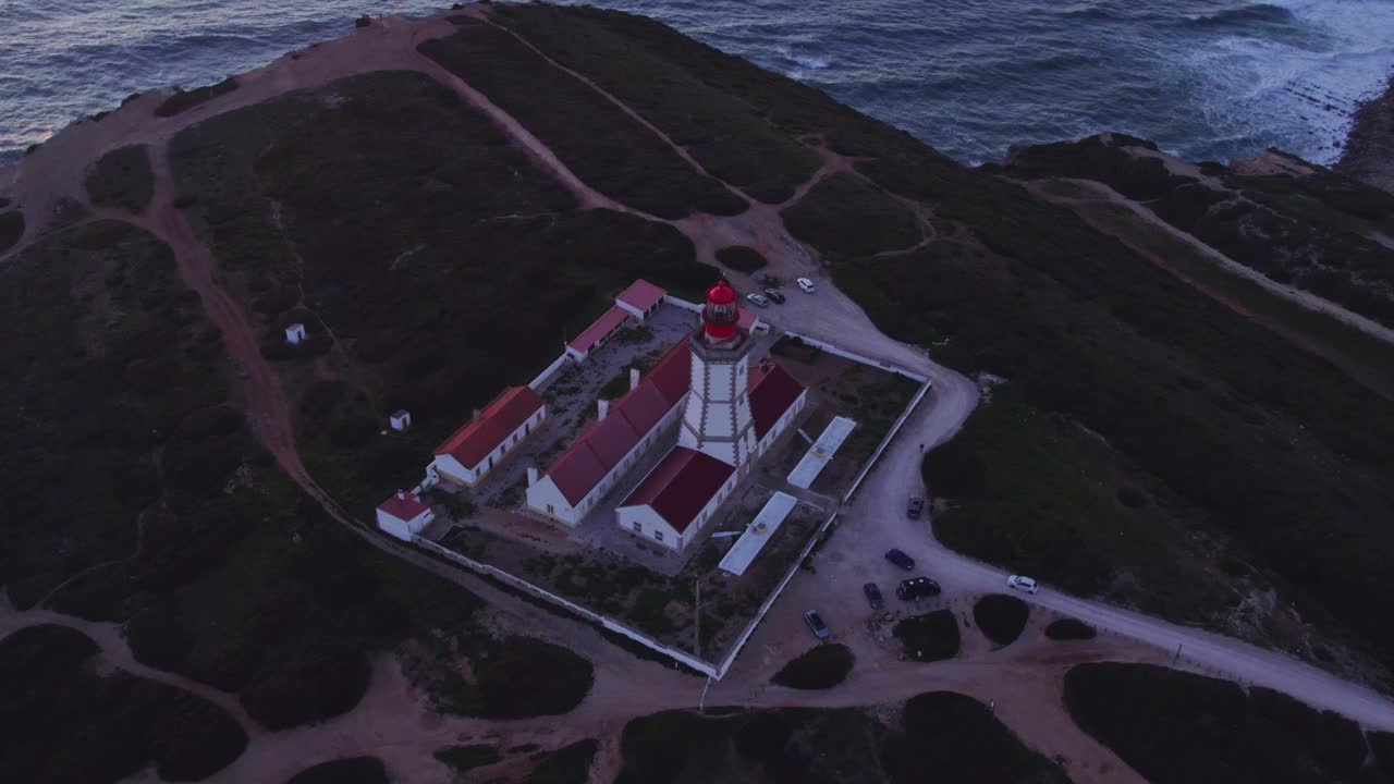 鸟瞰图的岩石海岸线与灯塔和悬崖在日落，葡萄牙。视频素材