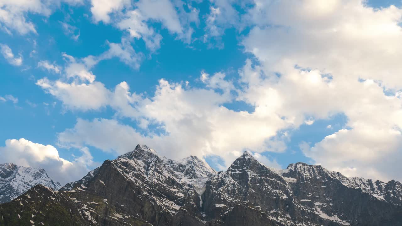 在印度喜马偕尔邦拉胡尔山谷的冈德拉，夕阳下，白雪覆盖的喜马拉雅山峰上的橙色云的4K延时拍摄。喜马拉雅山背景下的日落。视频素材