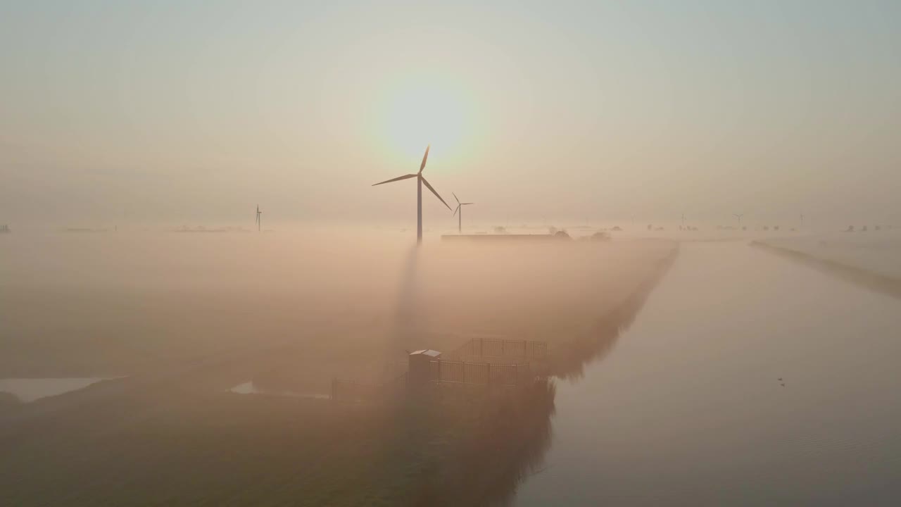 荷兰风力涡轮机农场上空雾蒙蒙的日出鸟瞰图。视频素材