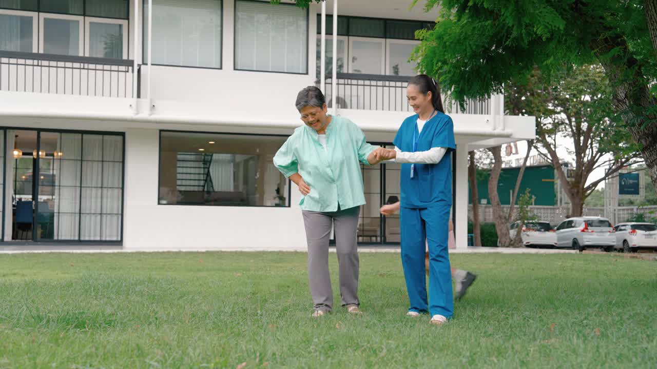 养老院正在帮助一位老妇人走在前院，她的孙女和儿子在旁边欢呼。医疗保健理念。视频素材