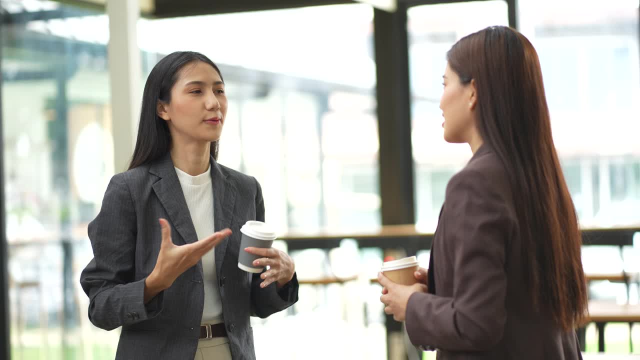 商务会议——两个亚洲女人在办公室聊天。视频下载