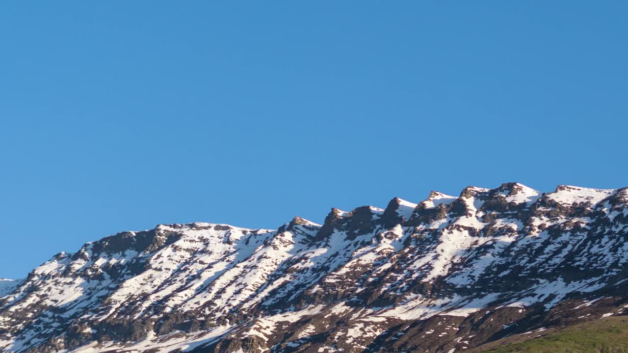 在印度喜马偕尔邦拉胡尔的基隆，日落时白雪覆盖的喜马拉雅山峰在日落时由白色变为红色。自然背景视频下载