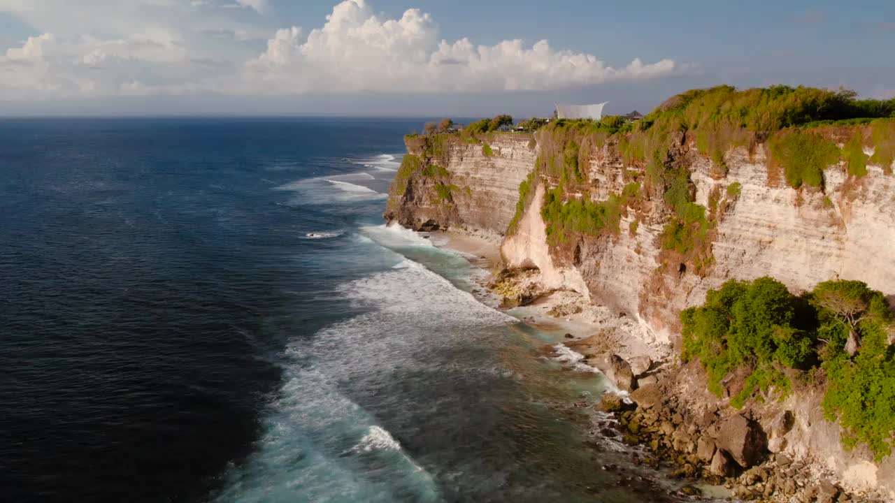 岩石悬崖海岸线和海洋，海，附近的乌鲁瓦图寺庙在巴厘岛，印度尼西亚视频下载