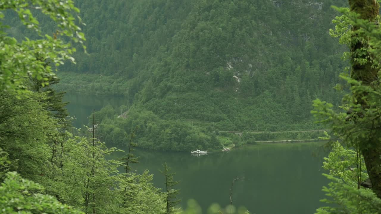 一个宁静的湖泊，周围环绕着郁郁葱葱的青山和茂密的森林，创造了一个宁静的自然环境。理想的主题自然，宁静，风景秀丽的风景。视频素材