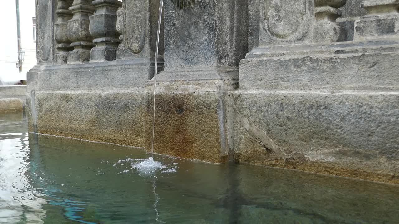 古老的石制喷泉，水流入池视频下载