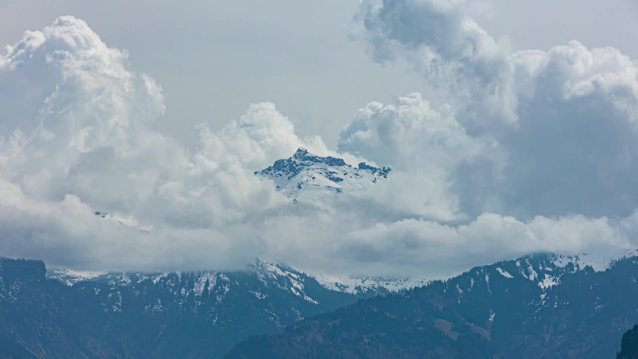 时光流逝，飘舞的云朵在山上覆盖着白雪。广州格拉鲁斯视频素材