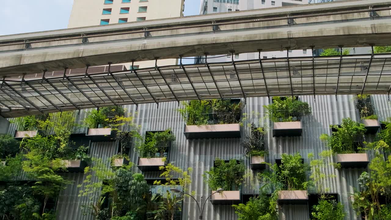 马来西亚吉隆坡地铁桥下现代建筑的垂直花园，绿色植物。可持续的现代生态建筑。生态友好型城市环境视频素材