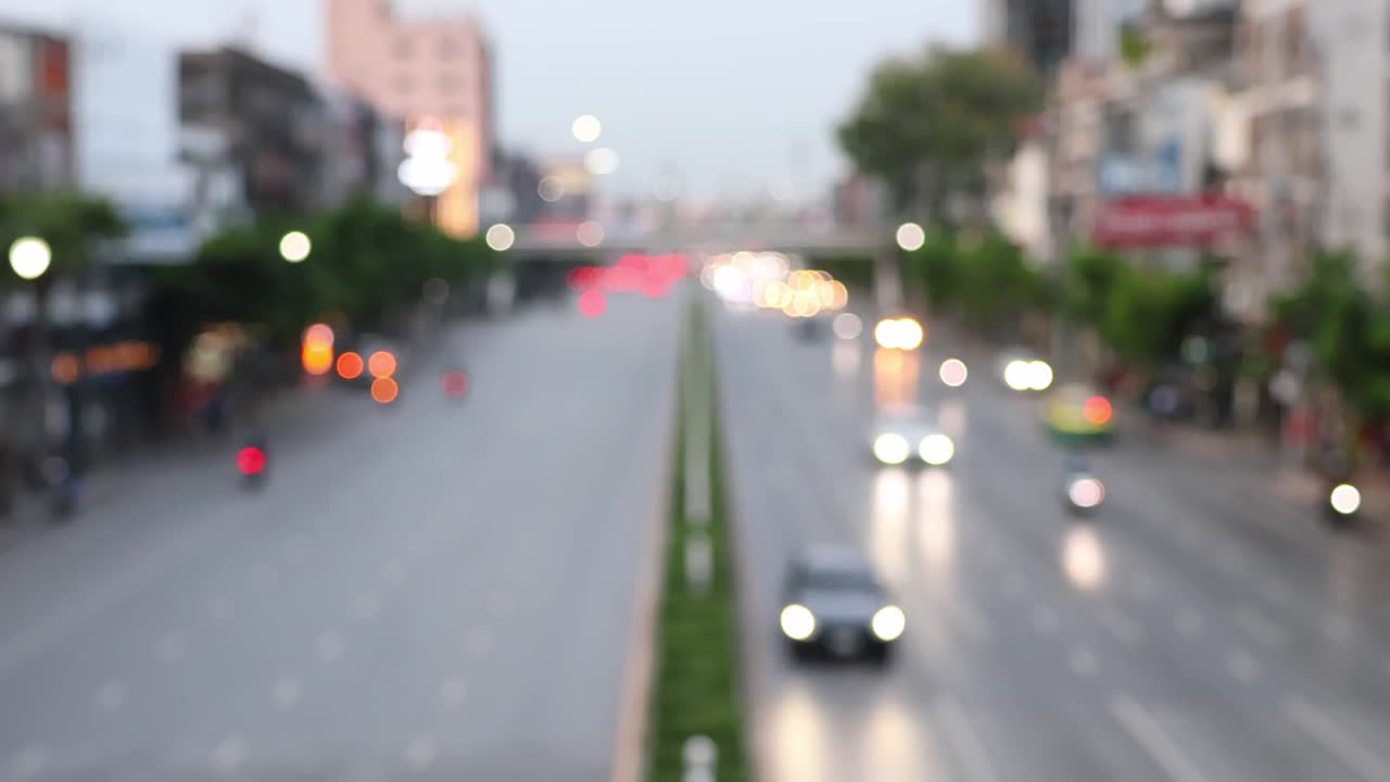 泰国曼谷吞武里区的道路交通。汽车散景和模糊的交通灯。视频下载