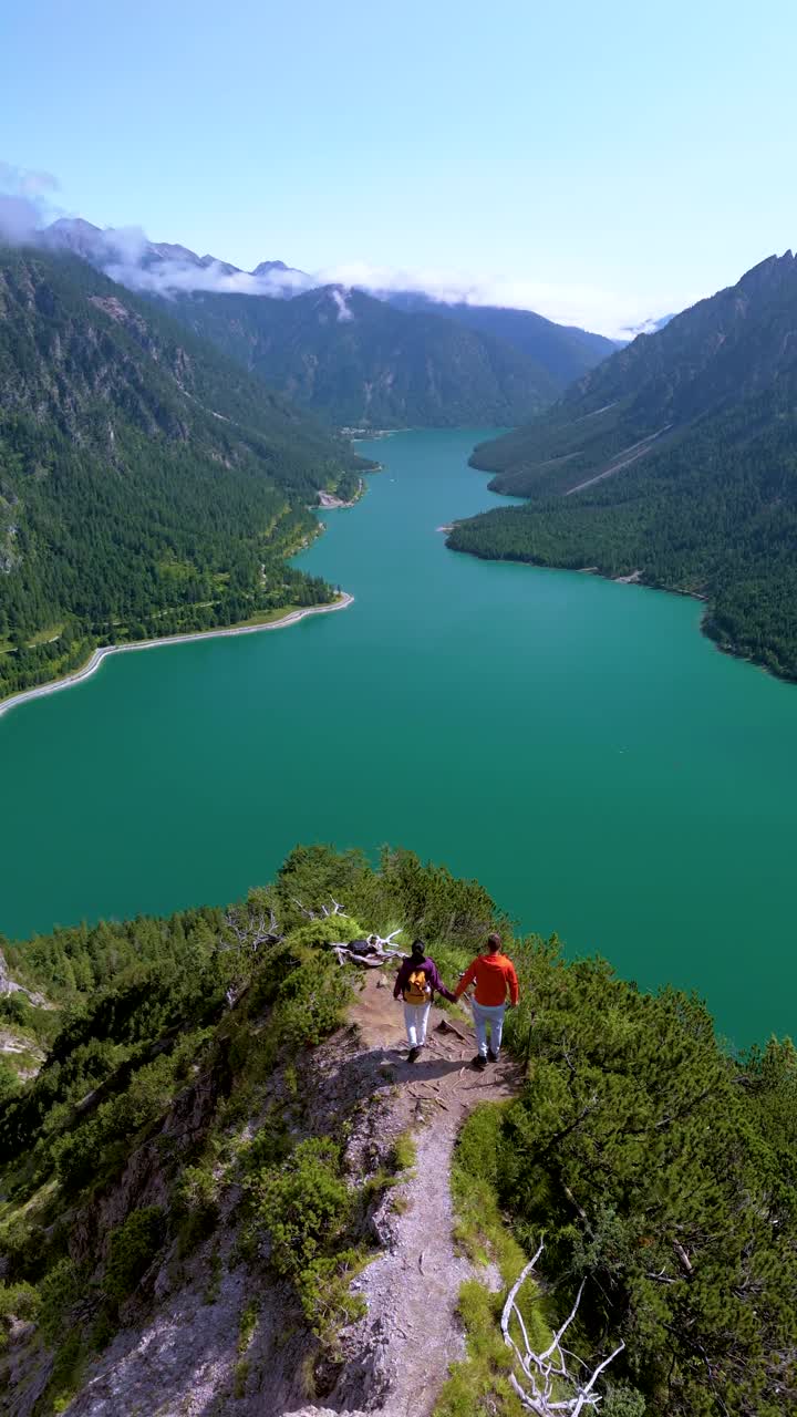 攀时奥地利，一对夫妇在令人惊叹的山景中徒步旅行视频素材