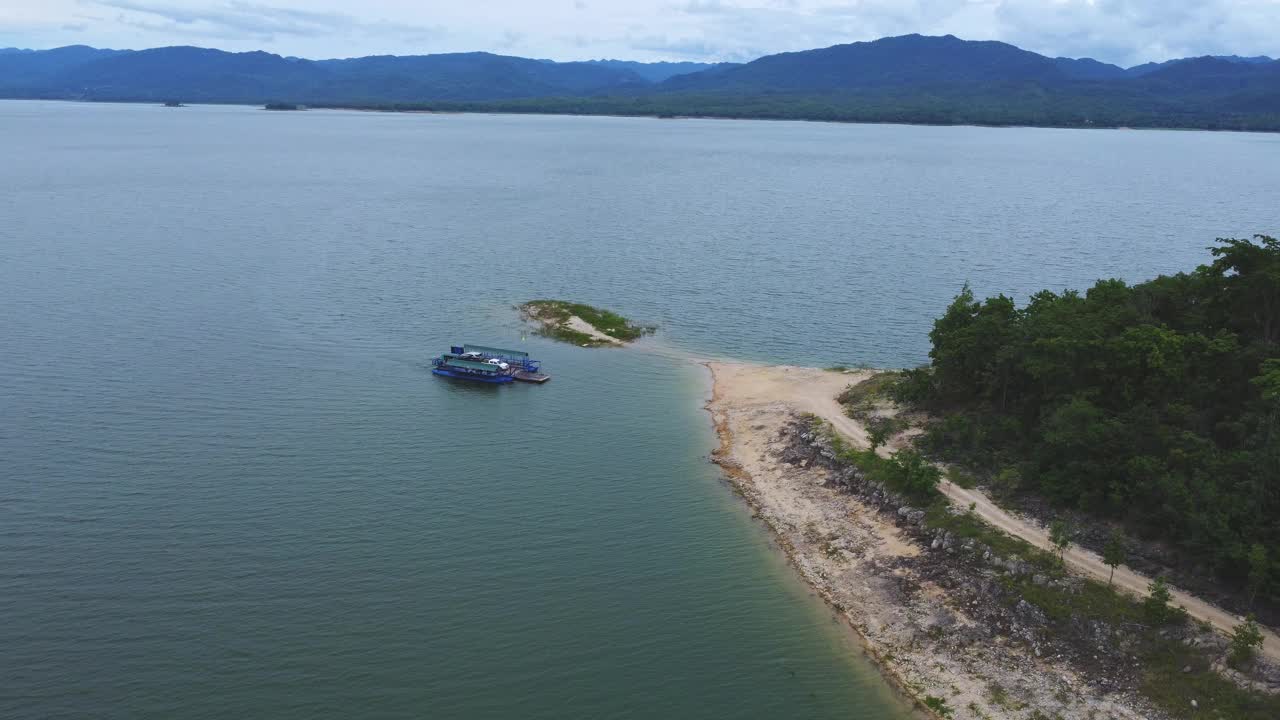 鸟瞰泰国北碧府当地运送汽车、摩托车和人过河的渡轮。视频素材