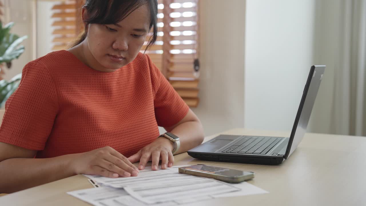 年轻女子正在计算财务支付账单视频素材