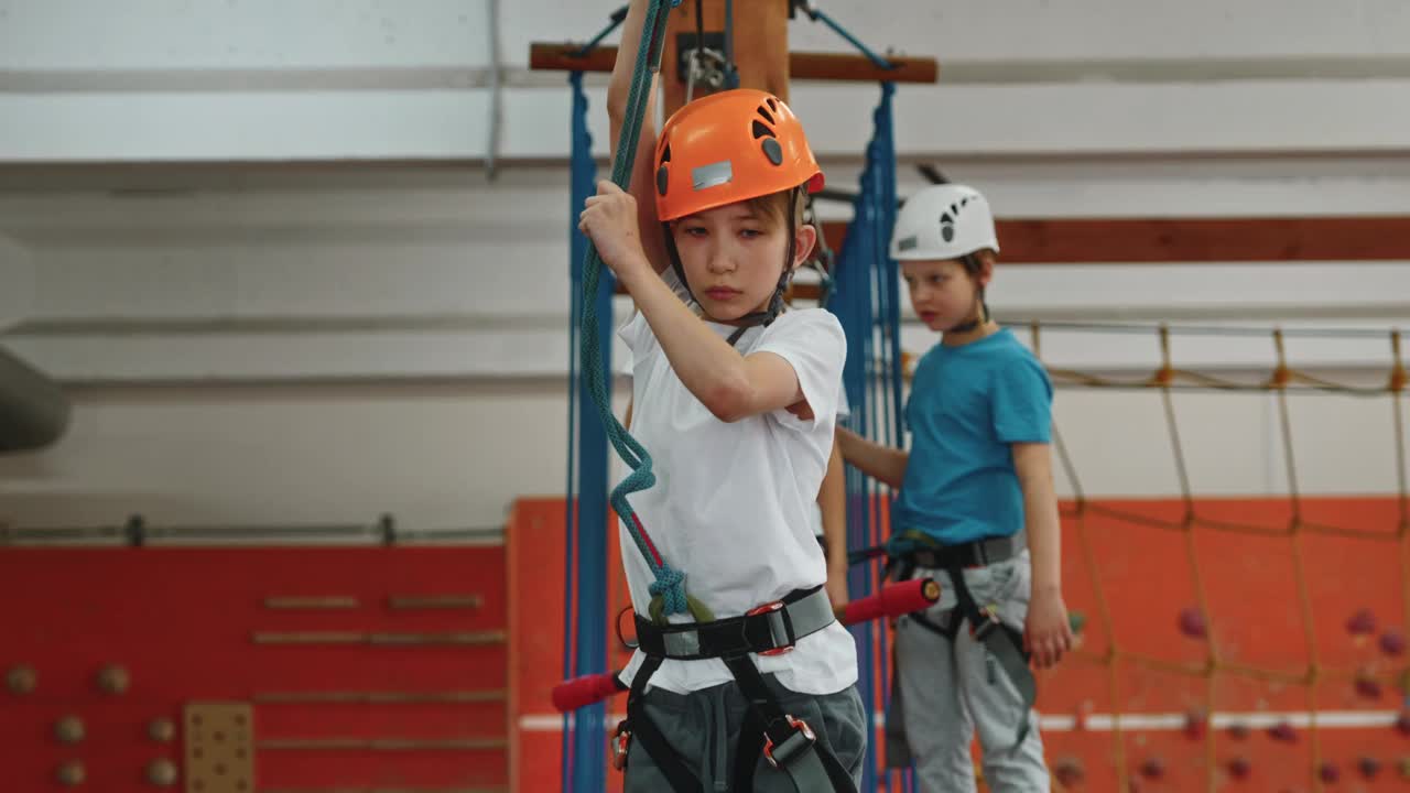 一个10多岁的男孩在高空绳索公园克服了障碍视频素材