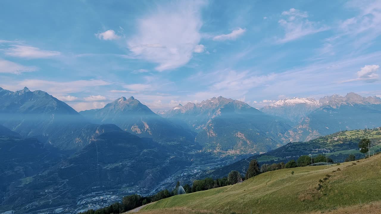 宁静的高山景观，郁郁葱葱的草地和雄伟的雪山视频素材