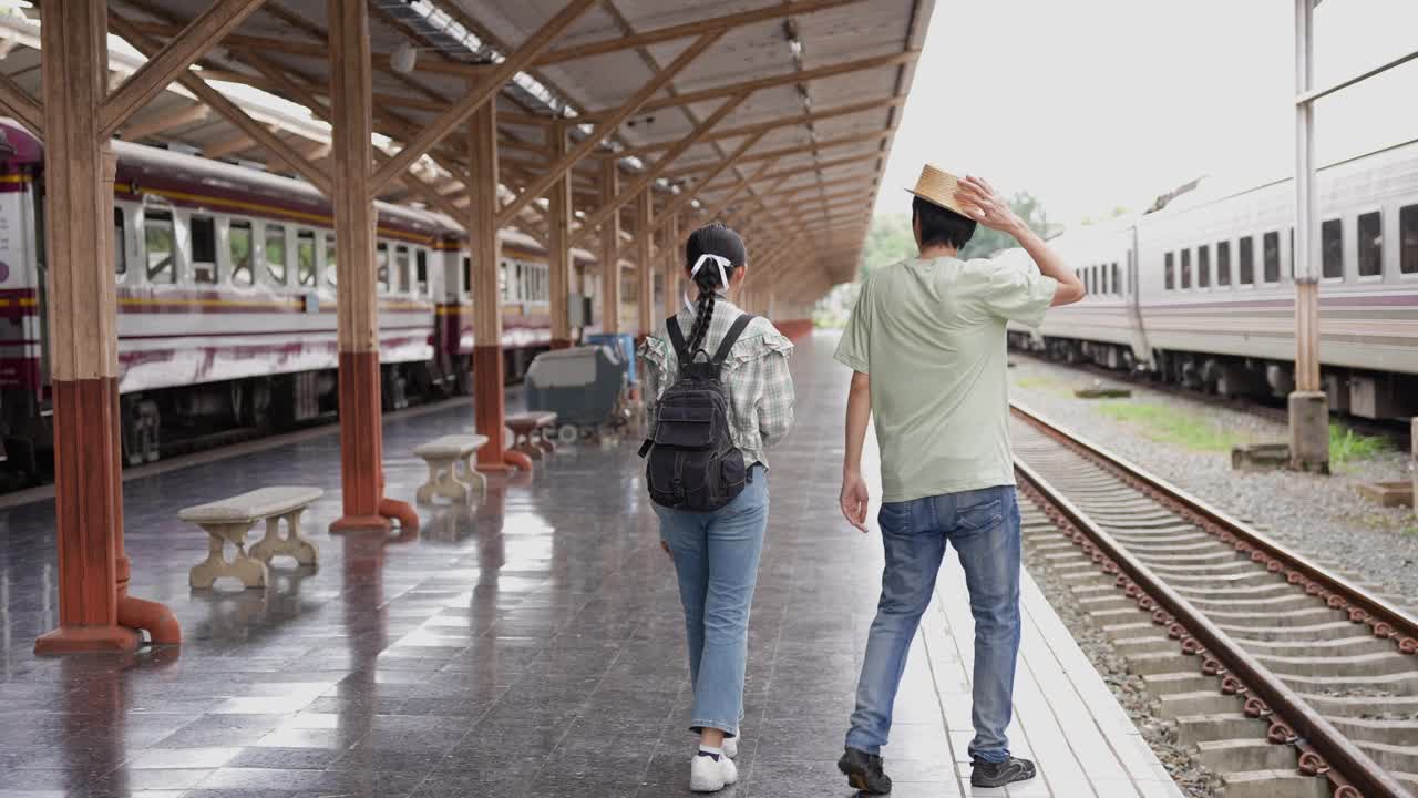 两名男女游客准备乘火车旅游。4K慢动作视频。视频下载