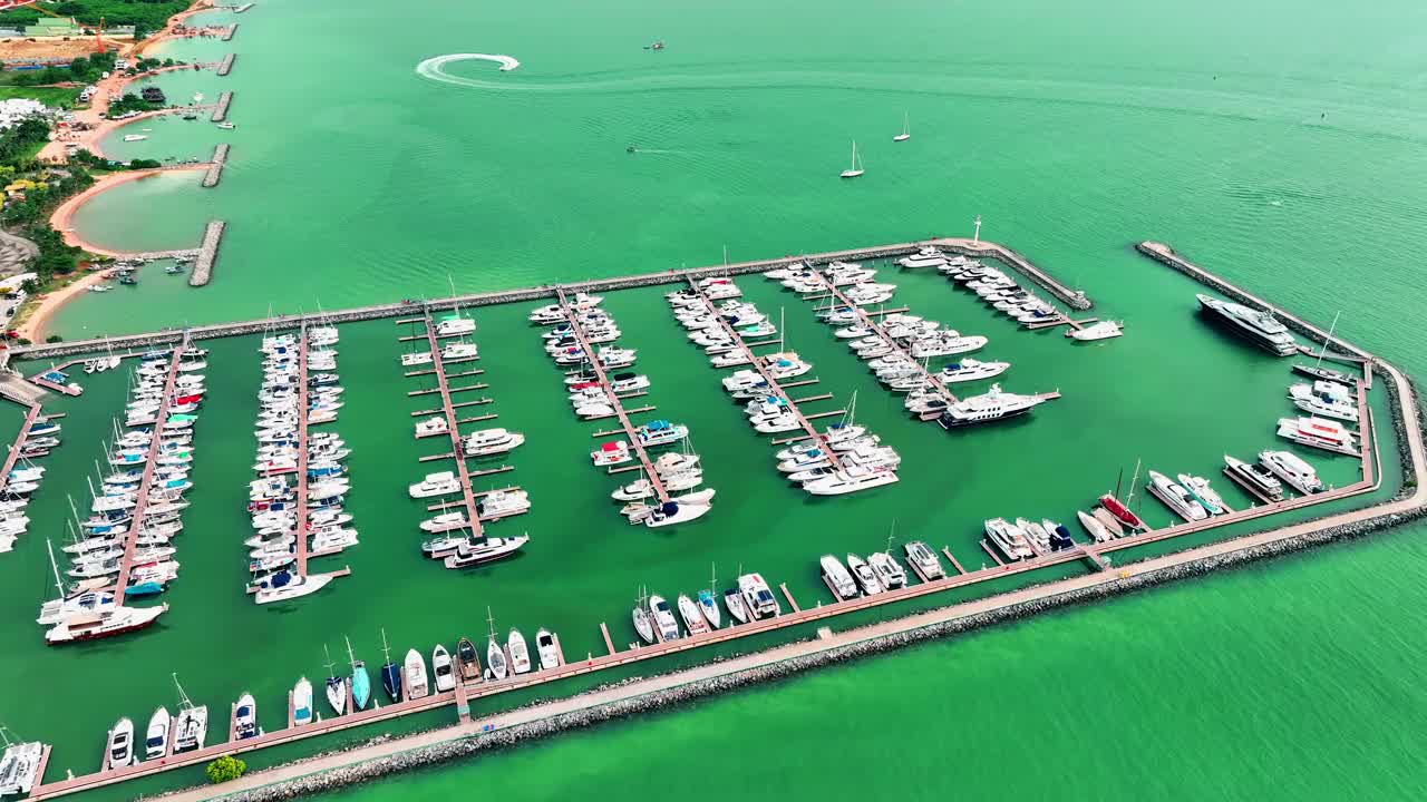 海上，港口，船只和城市建筑的空中无人机视图。度假小镇的壮丽景色，乘坐不同大小的游艇飞越滨海湾视频素材