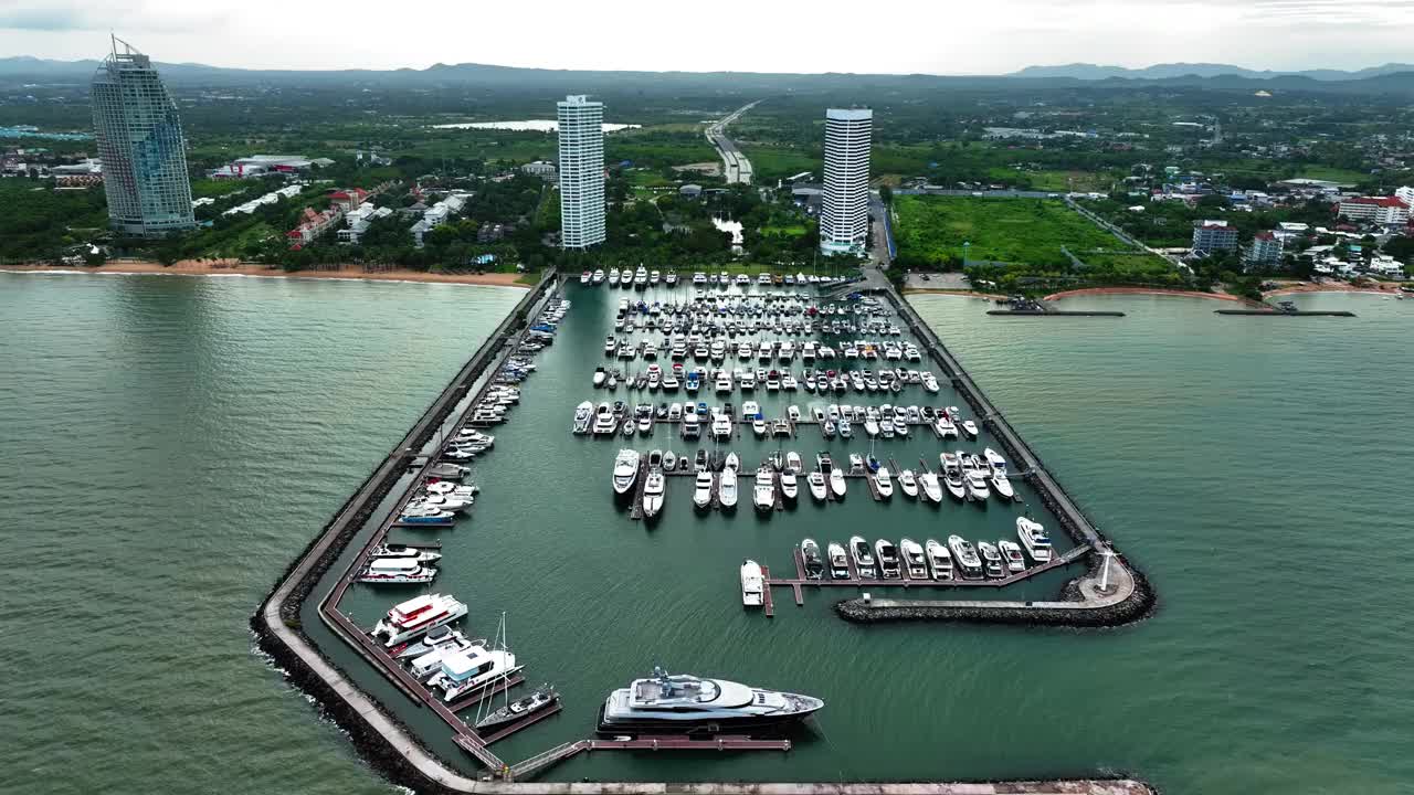 海上，港口，船只和城市建筑的空中无人机视图。度假小镇的壮丽景色，乘坐不同大小的游艇飞越滨海湾视频下载