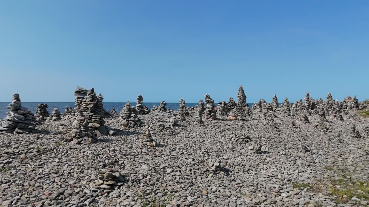 石塔海滩爱沙尼亚(波罗的海国家)，萨雷马岛，沿西南卵石滩海滩的平坦石头金字塔作为幸运符，奥萨萨雷图利克，基维兰德萨雷马岛，爱沙尼亚视频下载