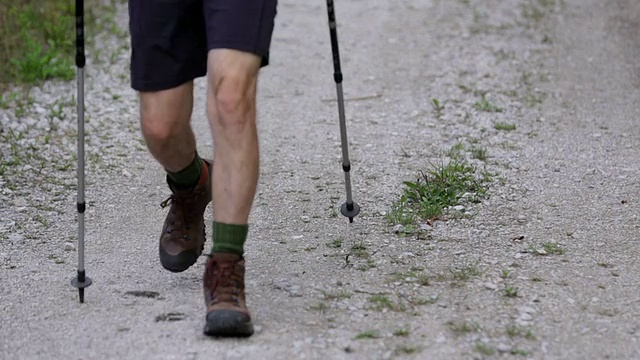 男性拿着登山杖走过视频素材