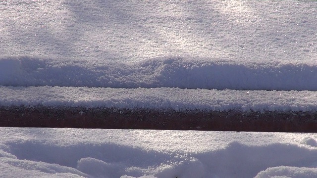 公园里的木凳上有雪和早晨的阳光视频素材