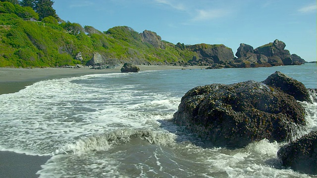 海浪撞击着美丽的绿色海滩海岸线。视频素材