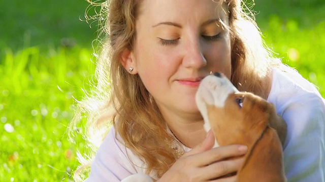 快乐的女人和一只小猎犬在大自然中嬉戏视频素材