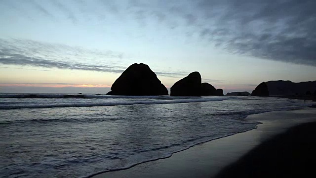 黄昏海滩的波浪和离岸岩石视频素材