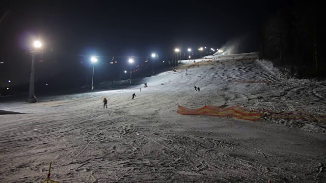 滑雪者在滑雪场和雪炮上滑行视频素材